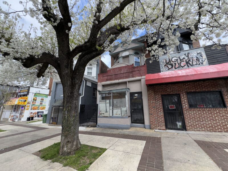 Street-level view of mixed-use building with storefront and sidewalk in Baltimore