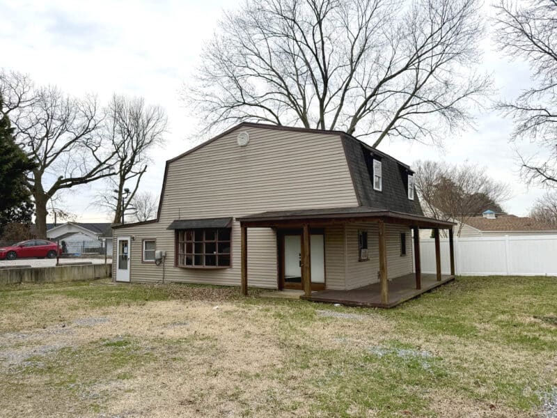 Converted barn building with covered front porch and large yard at 8226 Fort Smallwood Road