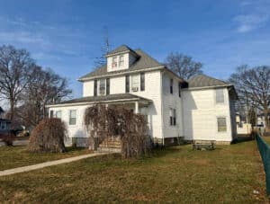 5 unit apartment building at 136 S Parke Street Aberdeen MD with covered front porch and landscaped yard