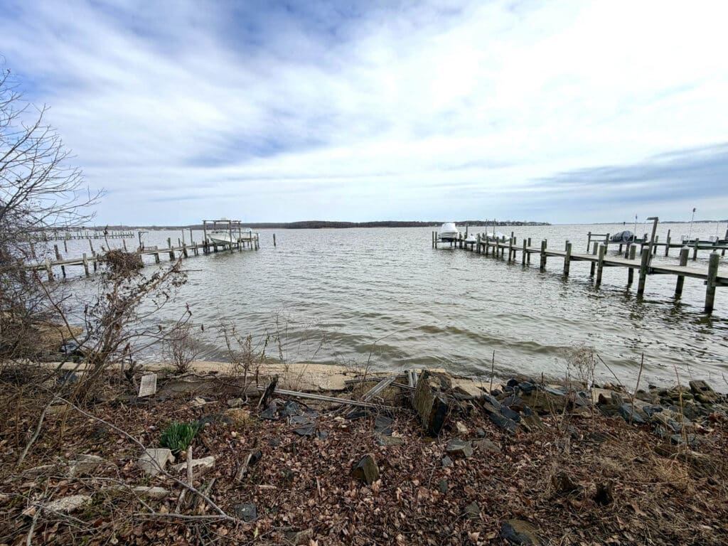 Waterfront view of Back River from 4327 Shore Road in Sparrows Point Maryland with private shoreline and surrounding piers