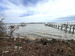 Waterfront view of Back River from 4327 Shore Road in Sparrows Point Maryland with private shoreline and surrounding piers