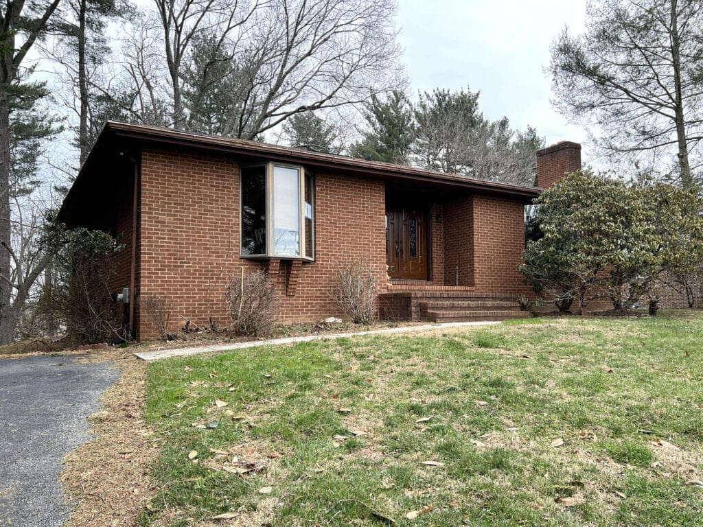 Brick rancher with front lawn and entry steps in Mt. Hebron Ellicott City