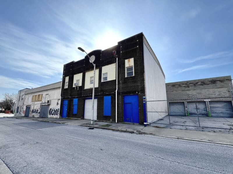 Brick warehouse building with multiple street-level doors in Jonestown Baltimore