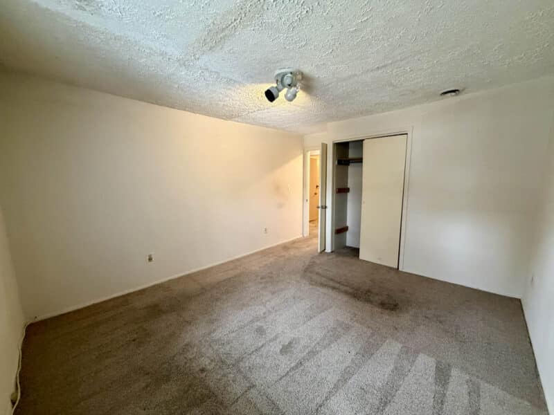 Bedroom with carpet flooring, closet, and neutral walls in converted barn apartment at 8226 Fort Smallwood