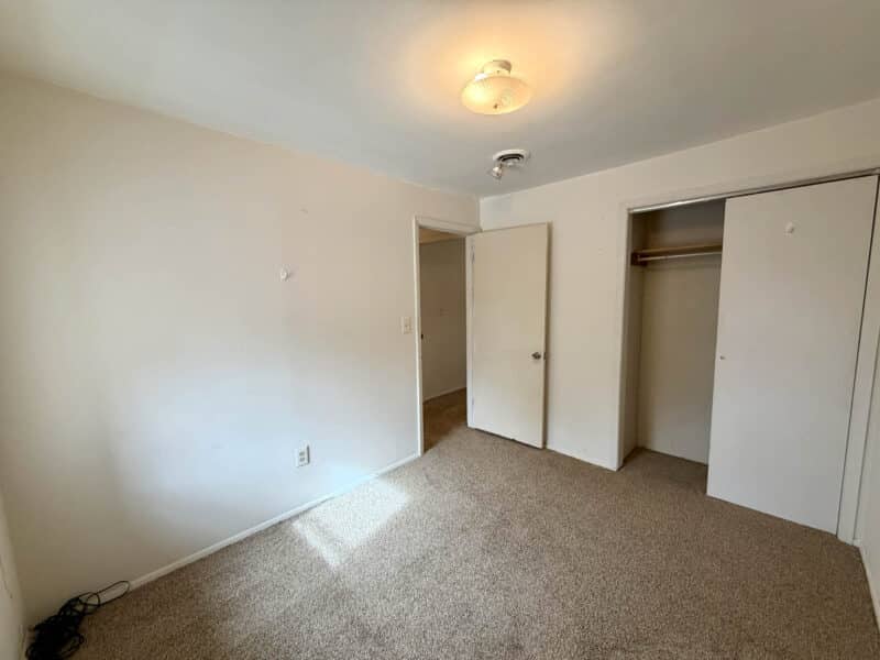 Bedroom with carpet flooring, closet, and neutral walls in converted barn apartment at 8226 Fort Smallwood