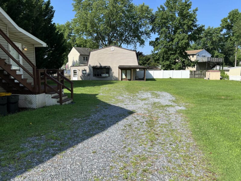 Expansive rear yard with multiple buildings including apartment structure and converted barn at 8226 Fort Smallwood Road