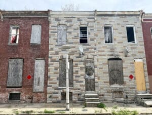 1611 N Chapel Street boarded shell townhome exterior in Broadway East Baltimore