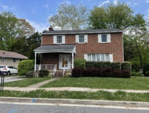 Front view of two-story brick detached home with covered porch in Perry Hall, Baltimore County