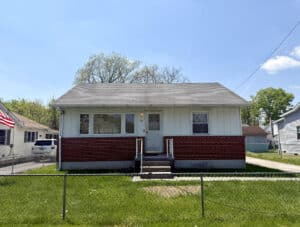 Front view of detached ranch-style home with brick and siding exterior and fenced yard in Victory Villa Middle River