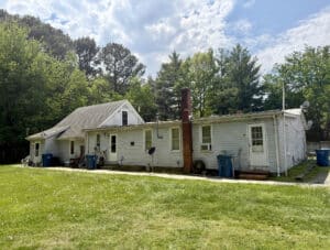 Exterior view of 5 unit apartment building with large grassy yard in Grasonville MD