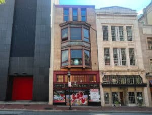 Four-story storefront building on North Charles Street in Downtown Baltimore with retail frontage and upper-level bay windows