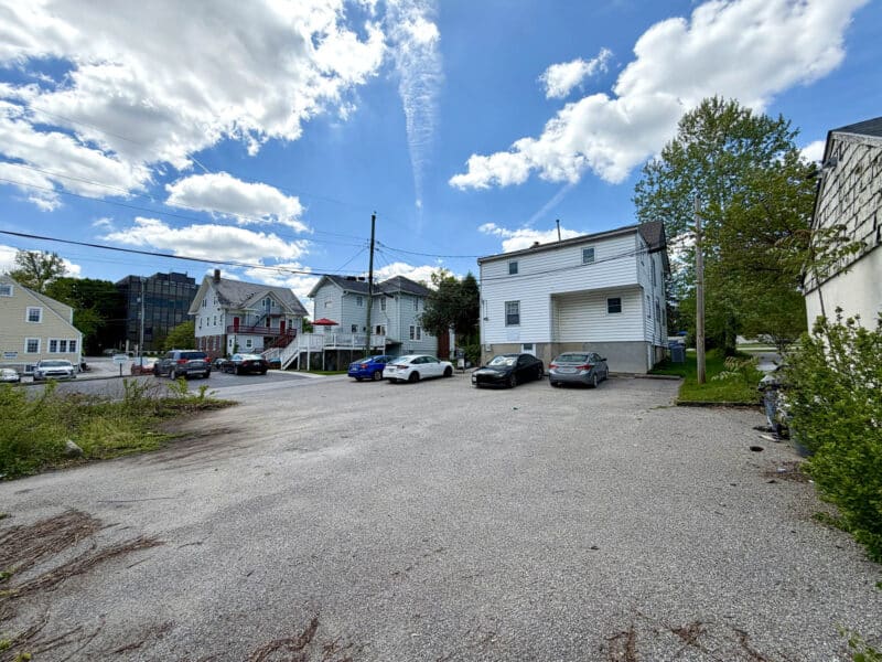 Large paved rear parking lot at 405 Central Avenue with space for 12 or more vehicles.