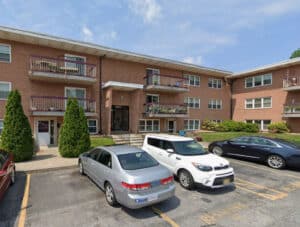 Front exterior of Regency Condominium brick garden apartment building