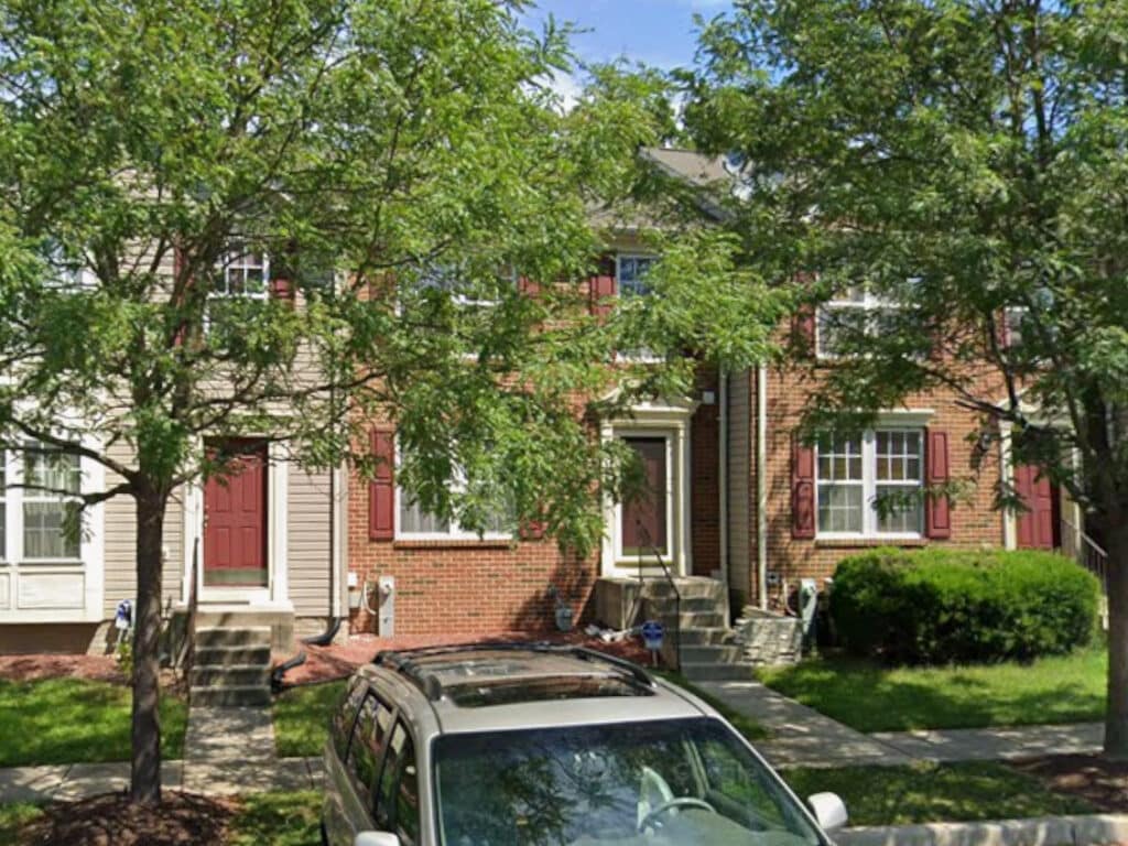 Two-story brick and siding townhouse in Granite Woods community Windsor Mill MD