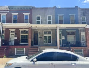 Front exterior of two-story brick townhome at 411 N. Ellwood Avenue in Baltimore City
