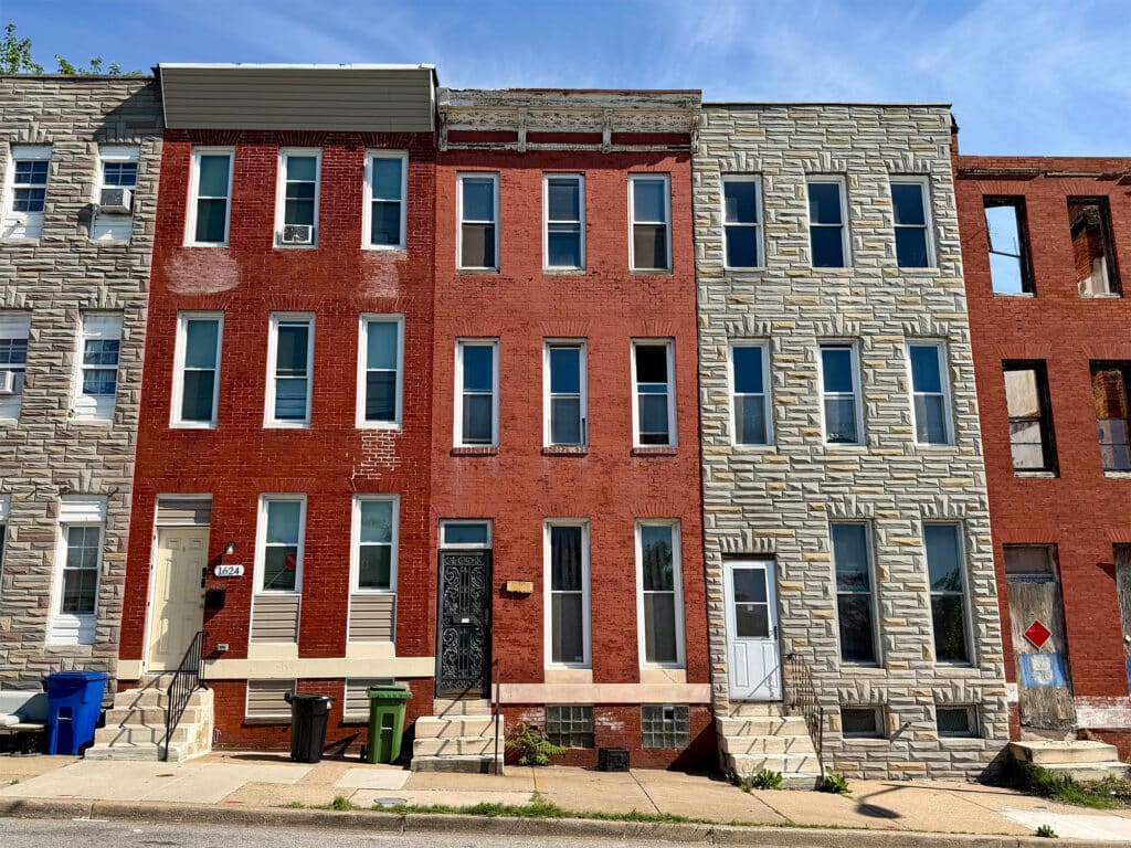 Front exterior of three-story brick townhome at 1622 W. Franklin Street in Harlem Park, West Baltimore.