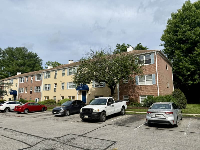 Angled exterior view of Highpointe Condominium building with parking area in Medfield Baltimore