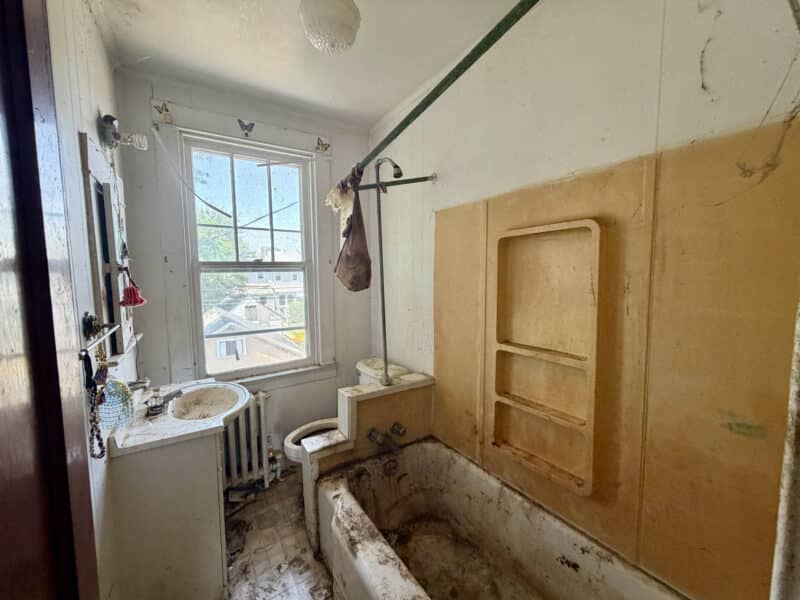 Full bathroom with original fixtures at 238 Baltimore Avenue in Dundalk requiring renovation