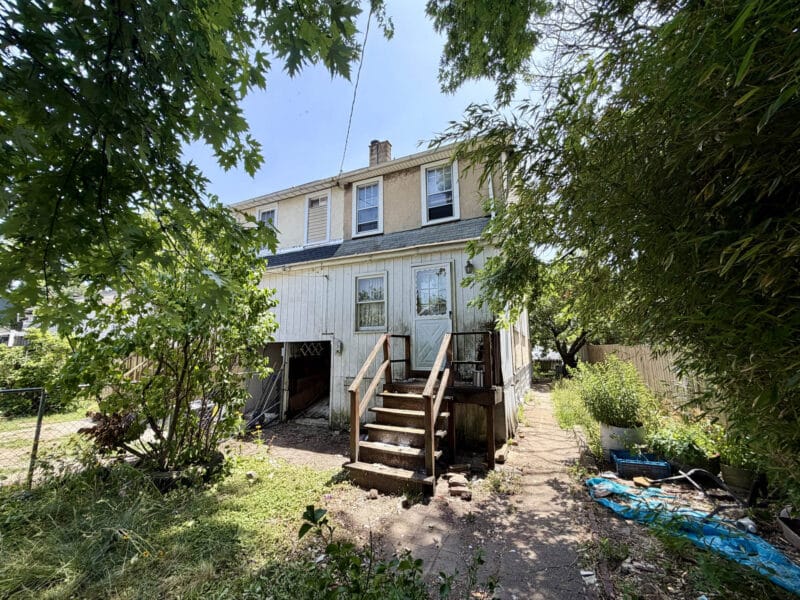 Rear exterior of 238 Baltimore Avenue showing rear entrance and fenced yard in Dundalk