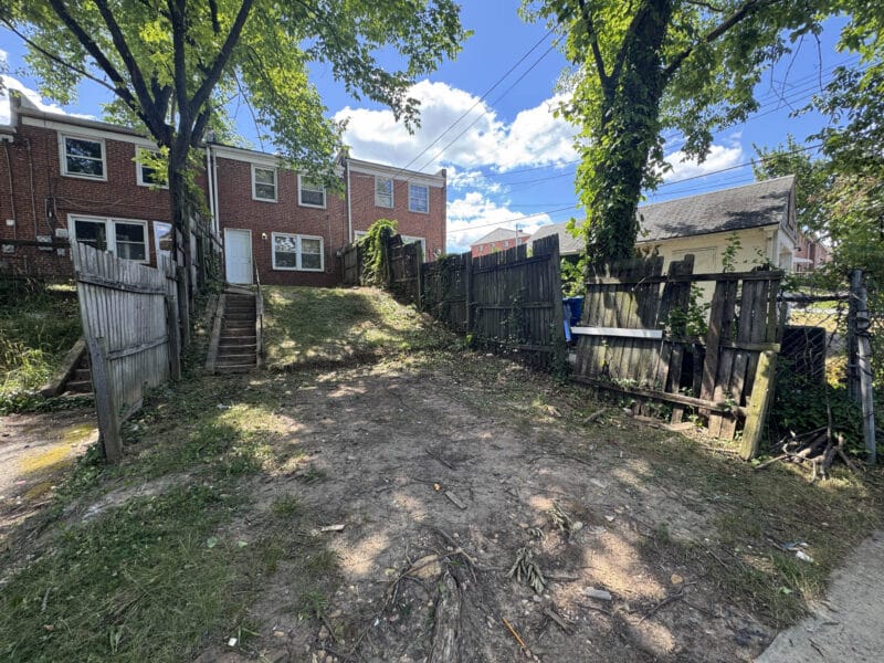 Rear view of 3040 Elizabeth Avenue showing the yard, rear access, and parking potential.