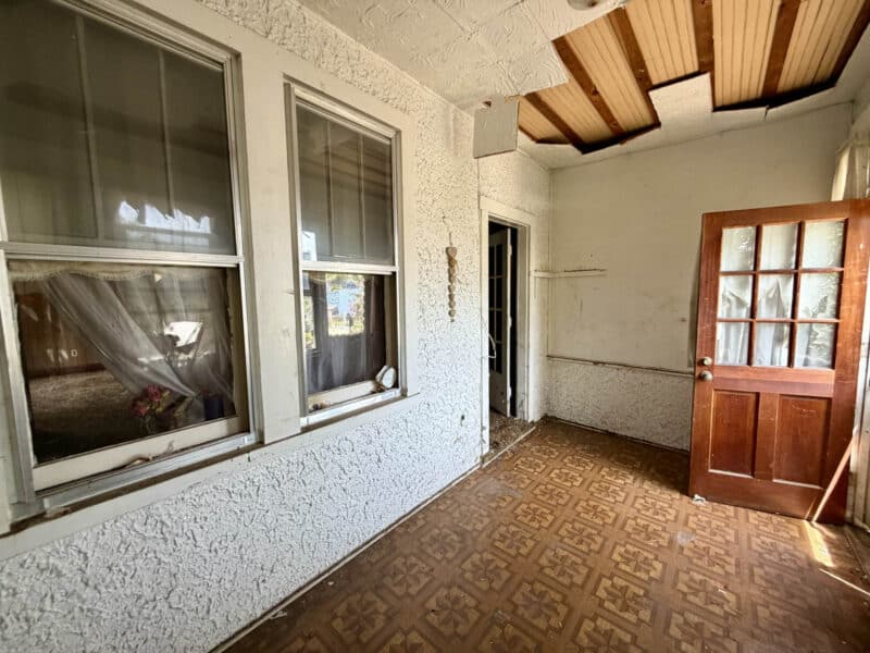 Enclosed front porch with patterned flooring and entry door at 238 Baltimore Avenue in Dundalk