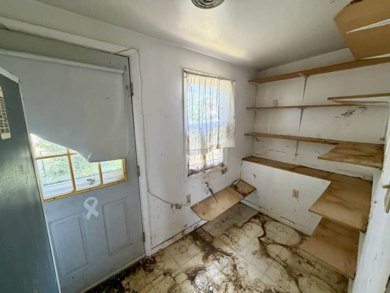 Rear mudroom with built-in shelving and exterior door at 238 Baltimore Avenue