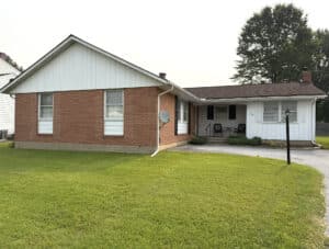 Front exterior of brick and siding rancher at 8327 Old Harford Road in the Lillian Estates neighborhood of Parkville, Baltimore County