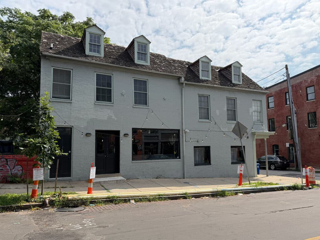 Front exterior of adjoining mixed-use buildings at 224-226 W. Read Street in Baltimore's Mount Vernon neighborhood with storefront and upper-level residential space.
