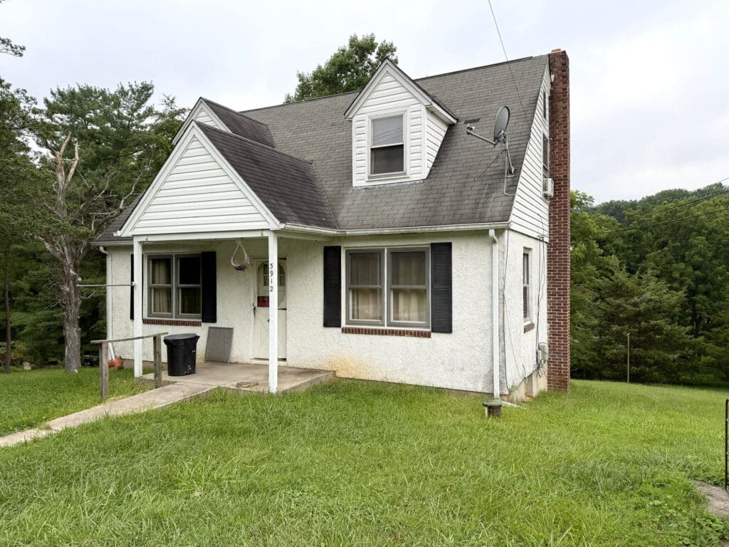 Front exterior of stucco bungalow with covered front porch at 3912 Wards Chapel Road in Marriottsville, Baltimore County, Maryland on a scenic 1.308± acre lot.