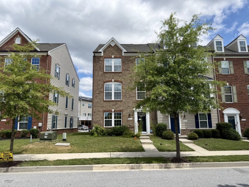 Front exterior of three-story townhouse at 9456 Ballard Green Drive in Ballard Green, Owings Mills, Maryland