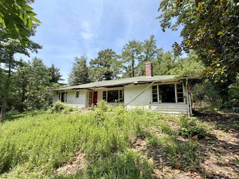 Rear exterior view of ranch home with wooded surroundings in Lexington Park, Maryland