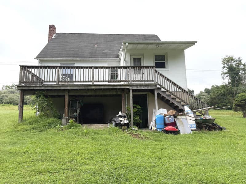 Rear exterior of Marriottsville bungalow with elevated wood deck, walk-out basement area and expansive backyard on a 1.308± acre lot in Baltimore County.