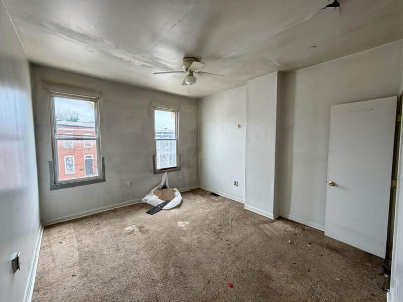 Front bedroom with carpet and ceiling fan at Washington Village/Pigtown Baltimore townhome