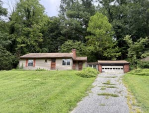 Front exterior of ranch home at 12 Gunpowder Road in Glen Arm, Maryland, with attached two-car garage.