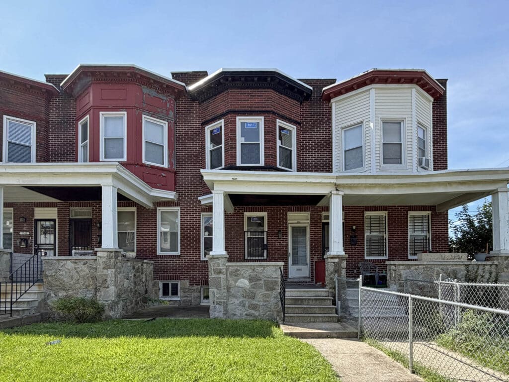 Front exterior of 2545 W. Lafayette Avenue, a brick porchfront townhome in Baltimore’s Bridgeview/Greenlawn neighborhood.
