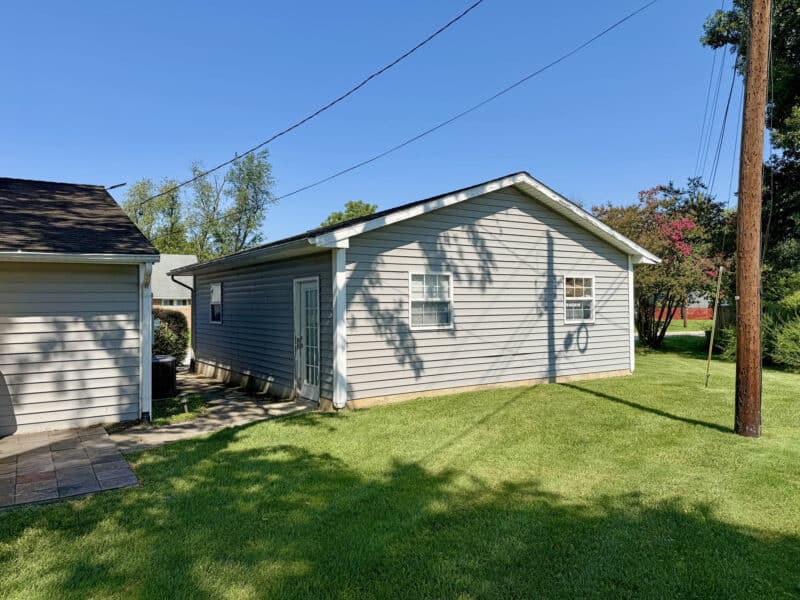 Detached two-car garage with roll-up garage doors and driveway.