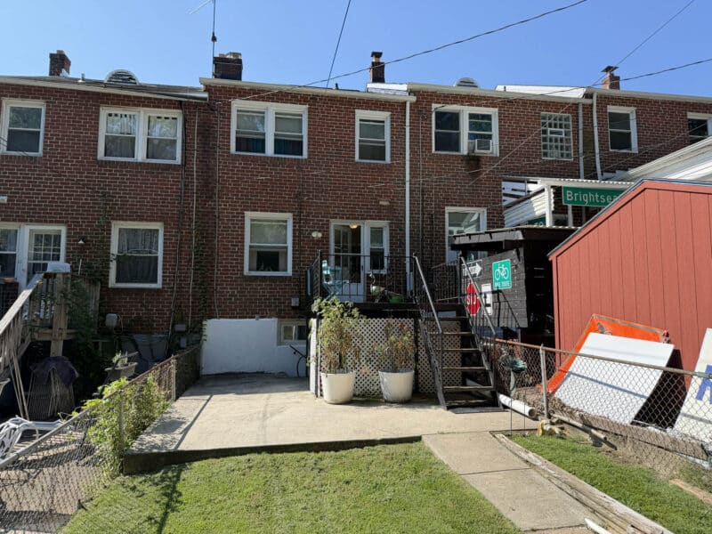 Rear exterior of 1204 Elm Road with fenced yard, concrete patio and rear porch