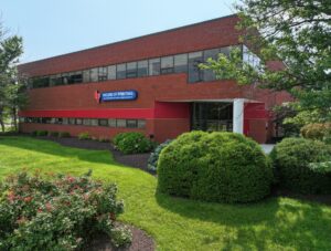 Front exterior of two-story brick flex industrial building at 15401 Old Columbia Pike in Burtonsville, MD.
