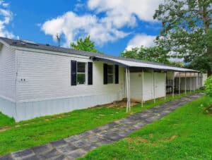Exterior of 1996 Skyline mobile home at 11540 Philadelphia Road, Lot #5A, White Marsh, MD, featuring vinyl siding and a covered walkway.