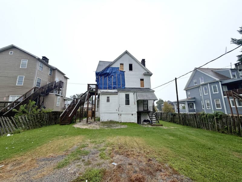Rear exterior and yard of fire-damaged detached home at 4108 Maine Avenue in Baltimore