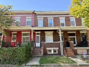 Front exterior of 1753 Montpelier Street, a two-story brick porchfront townhome in Baltimore City's Coldstream-Homestead-Montebello neighborhood.