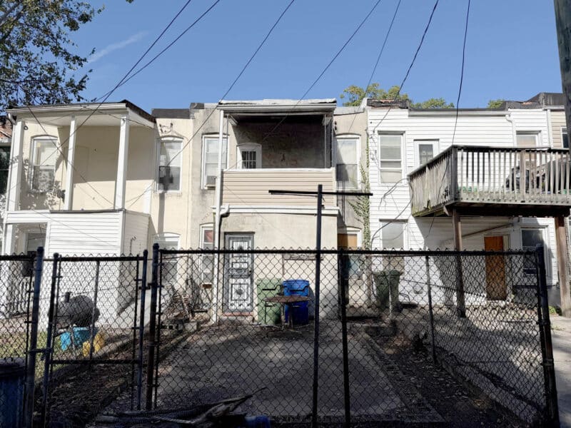 Rear exterior and fenced yard of the two-story townhome at 1119 Ellicott Driveway in Baltimore.